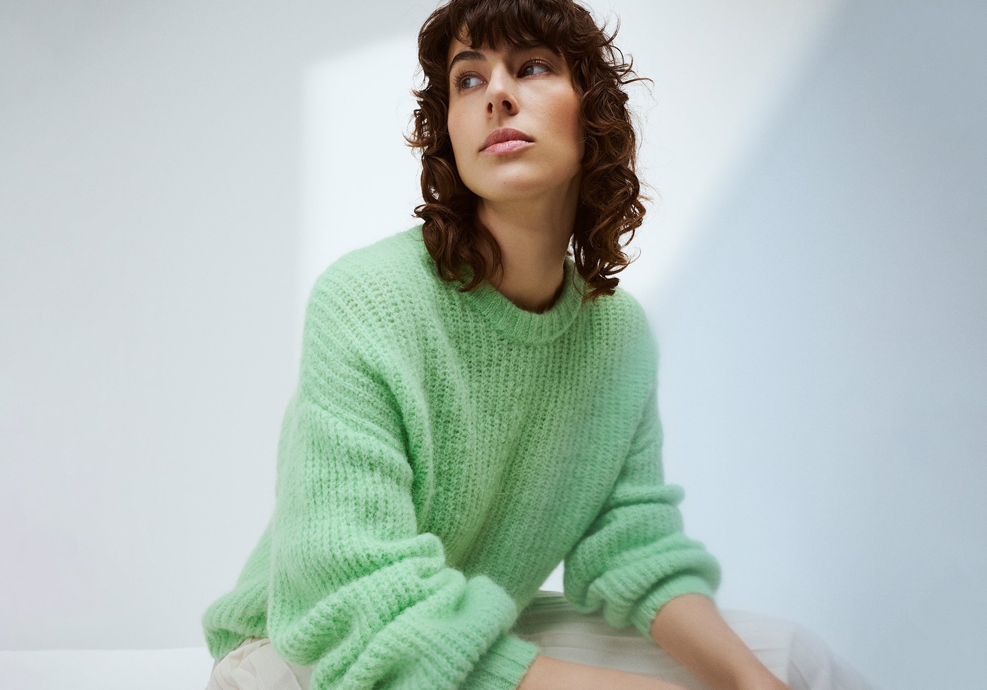 Nanson vaaleanvihreä Karamelli-neulepusero mallin päällä.