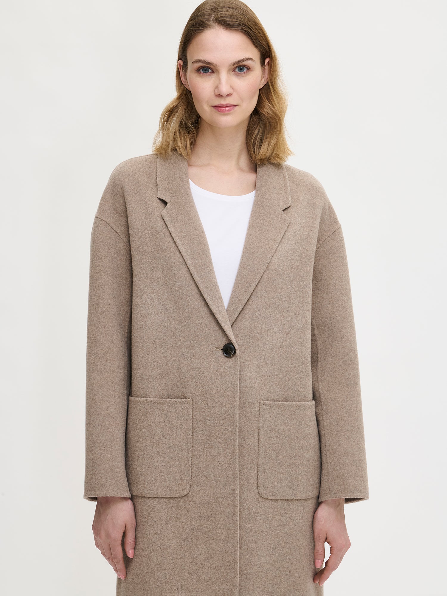 Nanson naisten tyylikäs ja klassinen beige Ylle-villakangastakki. Mallilla edestä lähikuvassa