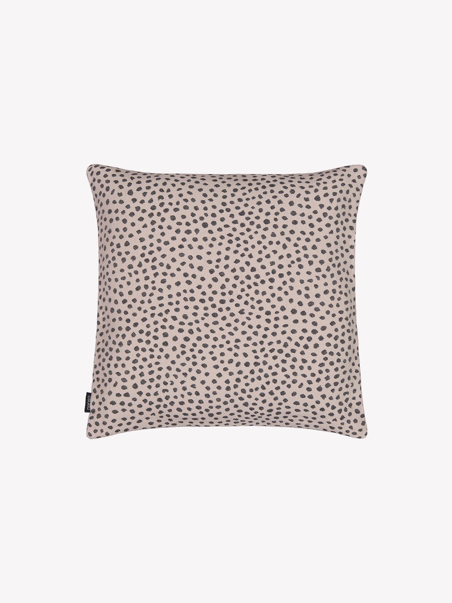 Beige Muru- tyynynpäällinen mustilla pilkuilla tuotekuvassa.