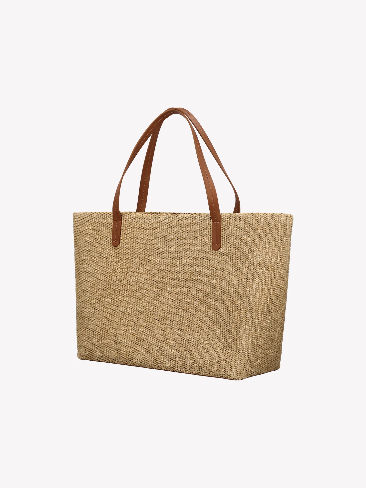 Tyylikäs Kori Tote- laukku kestävästä olkipunosta muistuttavasta materiaalista, kantohihnat ovat nahkaa. Vuoritetussa laukussa on tasku sisäpuolella ja magneettinappi kiinnitys. Tuotekuva takaa.