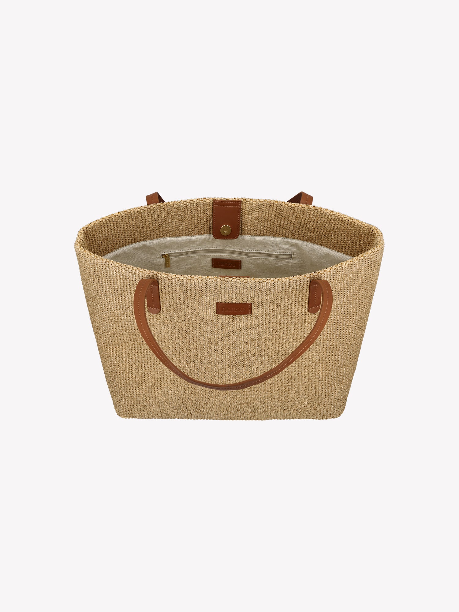 Tyylikäs Kori Tote- laukku kestävästä olkipunosta muistuttavasta materiaalista, kantohihnat ovat nahkaa. Vuoritetussa laukussa on tasku sisäpuolella ja magneettinappi kiinnitys. Tuotekuva ylhäältä.