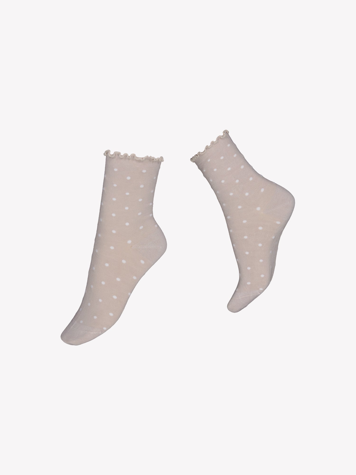 Voguen pehmeät beiget bambuviskoosisukat tuntuvat mukaville ja hengittäville jaloissa. Sukissa on pieni pilkkukuviointi sekä kaunis frillareunus. Tuotekuva sukista.